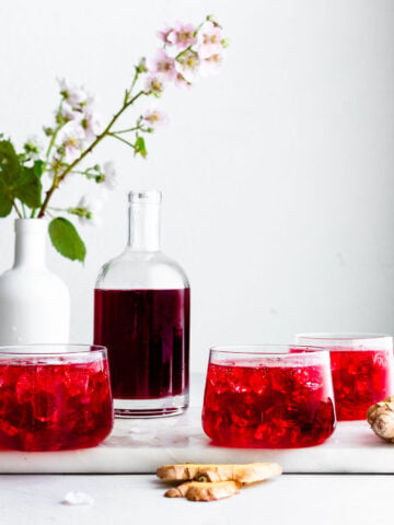 Blackberry switchel garnished with blackberries and blackberry flowers