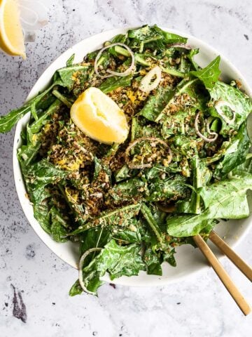 Dandelion salad garnished with breadcrumbs and lemon