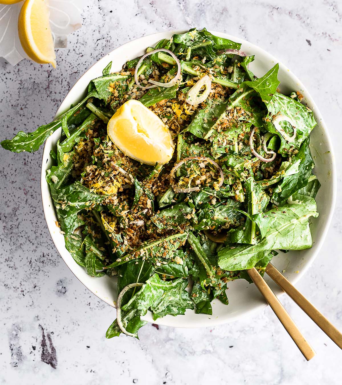 Dandelion salad garnished with breadcrumbs and lemon