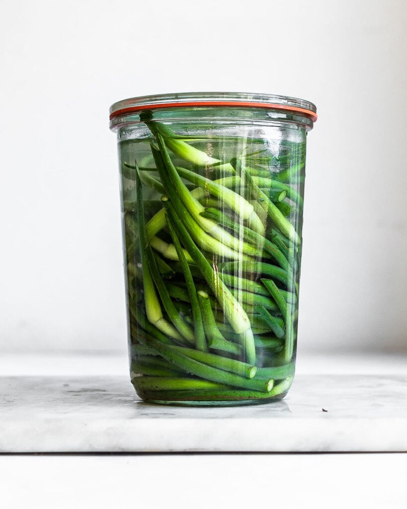 Garlic scapes in a glass jar 