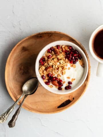 Filmjรถlk in a bowl, served with muesli and pomegranate seeds