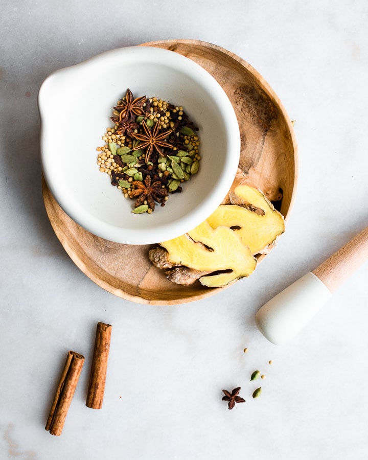 spices in a small bowl with ginger root