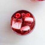 glass of raspberry shrub with ice