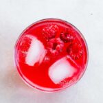 Glass of raspberry soda with ice