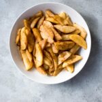 sauteed apples in a ceramic bowl on concrete