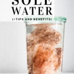 pinterest pin Himalayan pink rock salt in a glass with water
