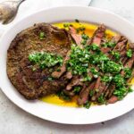 cooked flank steak on a plate