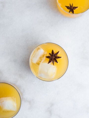 homemade tepache in a glass with ice and star anise