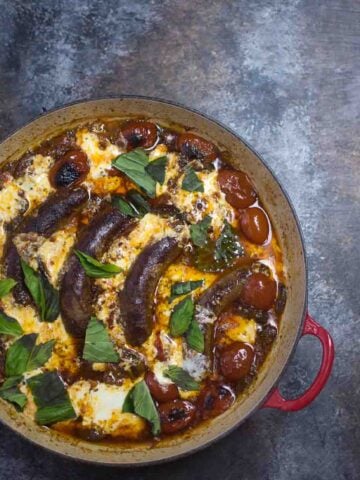sausages in a pot with cheese and tomato sauce