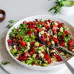 Tomato cucumber salad in white bowl