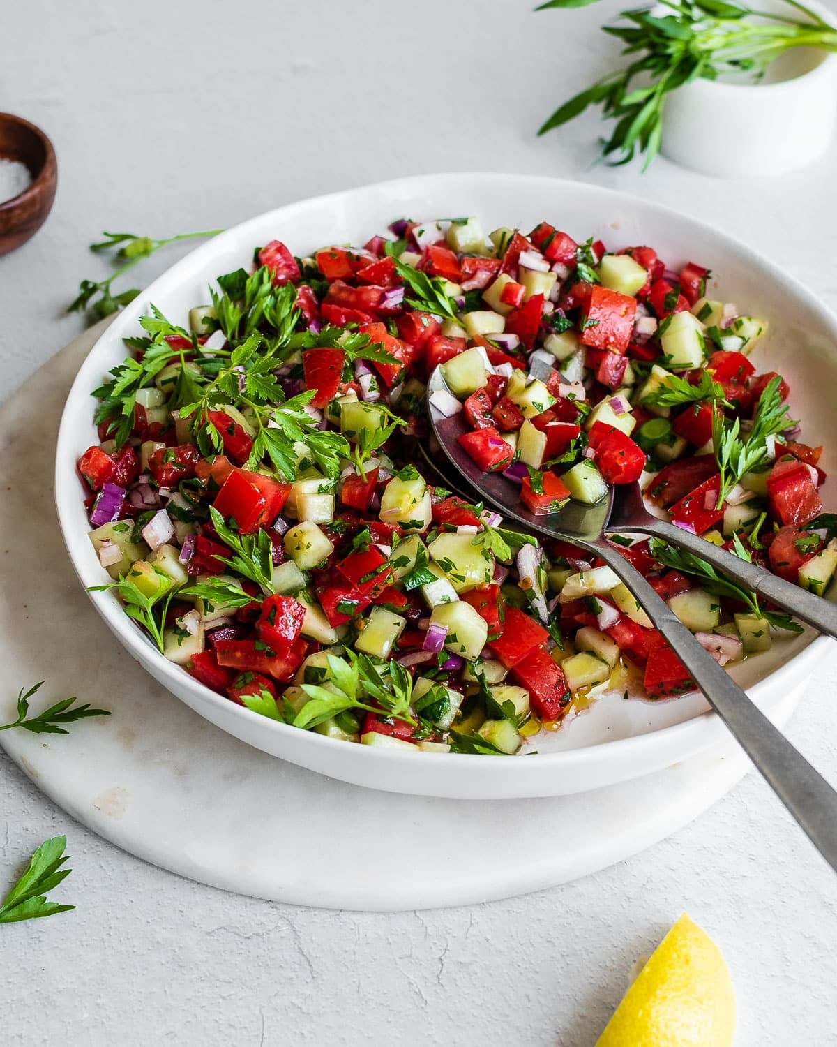 Tomato cucumber salad in white bowl