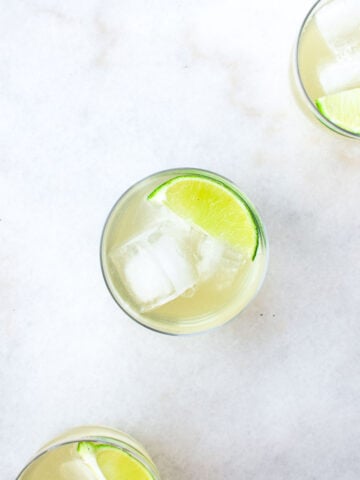 water kefir in a glass with ice and lime